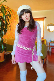 Cream daisy chain belt styled with a pink mini dress and white knee high socks in a retro indoor setting by Miracle Eye